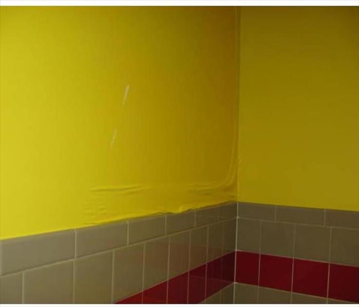 yellow paint bubbling after a pipe burst in the wall 