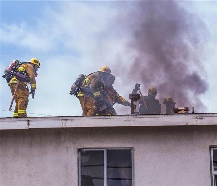 firefighters putting out fire on roof