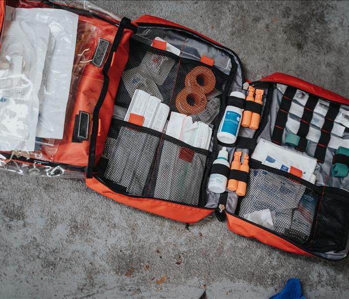 Orange emergency kit filled with supplies 